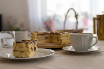 Festive cheesecake on the table with a cup of coffee. Easter time.