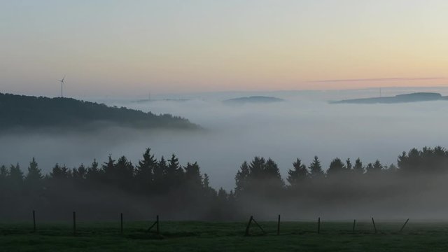 Waves of fog rolling over hills in Luxembourg