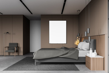 Beige bedroom with vertical poster and armchair