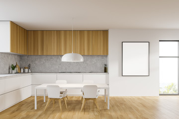 Table and countertops in white kitchen with poster