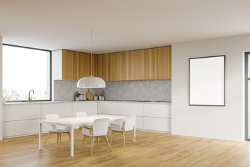 White and wooden kitchen corner, table and poster
