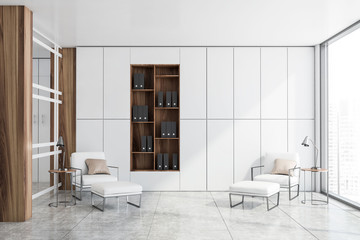 White office lounge with armchairs and bookcase