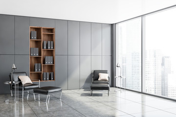 Gray office lounge corner, armchairs and bookcase
