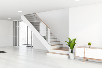 White living room with cabinet and stairs