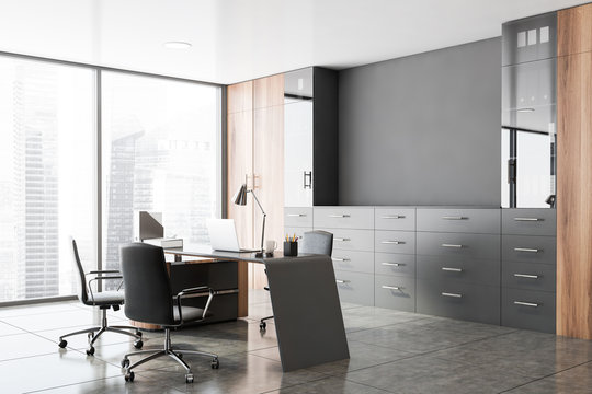 Gray and wooden CEO office corner