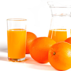 glass of fresh orange juice with fresh fruits on white background