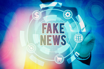 Writing note showing Fake News. Business concept for false information publish under the guise of...