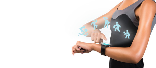 Young woman looking at smart watch while exercising