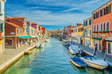 Fototapeta na wymiar Murano islands with water canal, boats and motor boats, colorful traditional buildings, Venetian Lagoon, Province of Venice, Veneto Region, Northern Italy. Murano postcard cityscape.