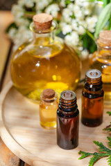 Assortment of natural oils in glass bottles on wooden background. Concept of pure organic ingredients in cosmetology. Atmosphere of harmony, relax, spa. Close up macro. Healthy lifestyle