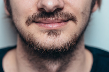 Obraz premium Close portrait of an unshaven man with a mustache and beard.