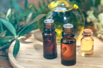 Assortment of natural oils in glass bottles on wooden background. Concept of pure organic ingredients in cosmetology. Bath accessoiries, atmosphere of harmony, relax. Close up macro. Healthy lifestyle