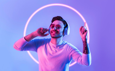 Guy dances to favorite music in neon circle