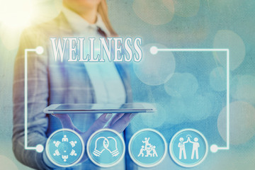 Conceptual hand writing showing Wellness. Concept meaning state of being in good health especially...