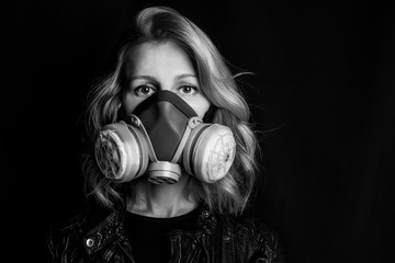 air pollution and virus theme. Conceptual photo woman eyes of young woman in respirator. Black white emotional artistic creative long exposure dramatic portrait. disaster survival. 