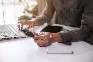 Businessman using a credit card and digital laptop