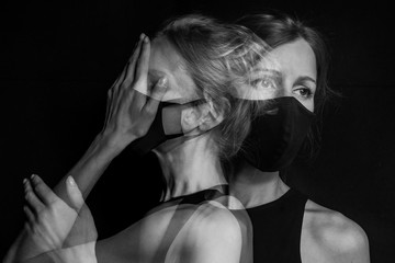 dramatic black and white portrait of young beautiful woman in face mask. Personal protection....