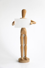 Wooden mannequin standing with blank sign protesting or begging because unemployed or marketing