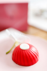 red mousse cake on a pink plate