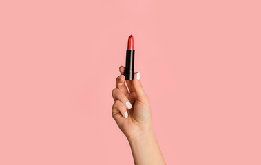 Fashion and makeup. Closeup of girl showing red lipstick on pink background - obrazy, fototapety, plakaty
