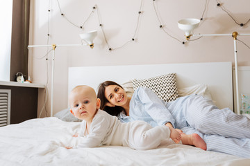 Fototapeta premium Mother and baby playing in the bed .