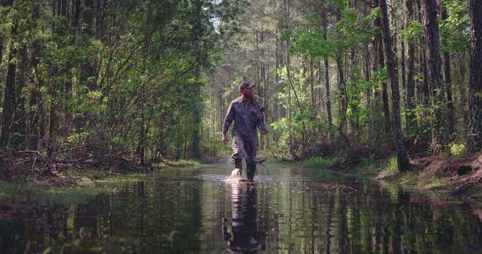 Man walking through puddle while hunting