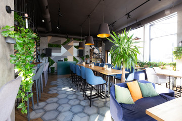 Light modern interior of urban restaurant or cafe with dining places