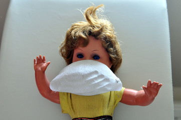 Doll with face mask for protection against corona virus