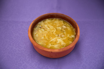 purple backgrounds . Erishde dish, eggplant stuffed dish and cucumber, tomato salad . Kesme, egg noodle , Kyrgyz, Azerbaijan cuisine, Traditional assorted dishes, Top view.