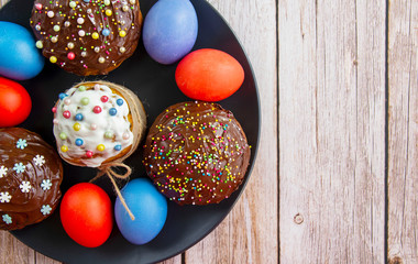 Decorated pumpkin cakes with chocolate, candied fruits and colored Eggs