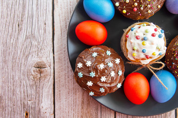 Decorated pumpkin cakes with chocolate, candied fruits and colored Eggs