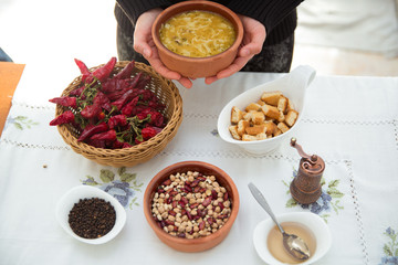Erishde dish purple backgrounds . Erishde brown bowl . Vinegar on a small white bowl . Kesme, egg noodle , Kyrgyz, Azerbaijan cuisine, Traditional assorted dishes, Top view.