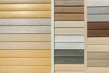 Vinyl siding with imitation wood texture in bright palette of colors. Plastic wall covering for exterior decoration of house. Abstract background for your design with copy space and place for text - obrazy, fototapety, plakaty