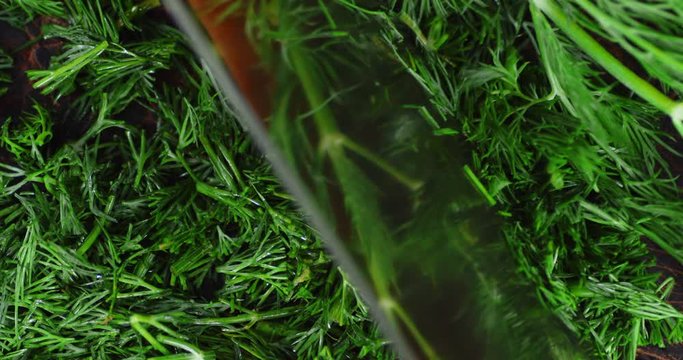 Fresh dill crushed with a large knife.