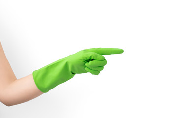 Hand with green rubber protective glove points to the side right, isolated on white gesturing,...