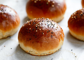 fresh homemade hamburger buns, baps on baking paper