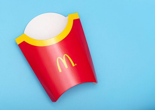 BERLIN - APR 19: Empty Paper Box For McDonald's  French Fries On Blue Background In Berlin On April 19. 2020 In Germany