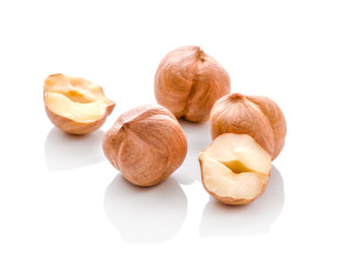 Full and halfs of hazelnuts on white background. Isolated