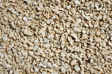 Scattered, small bright stones with sharp edges - grits.