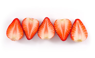 Decorative layout of halves of strawberries on a white background top view. Isolated