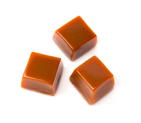 Trhee cubes of caramel on white background. Top view. Isolated