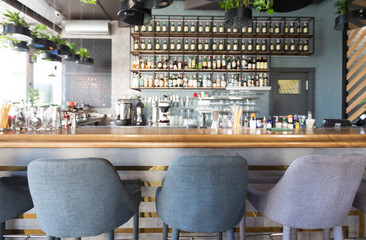 Bar counter with soft chairs in cafe with no visitors