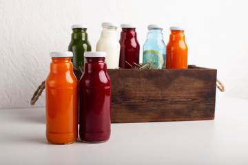 Healthy and useful colorful detox cocktails inside wooden box