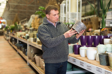 Man choosing pot for plants