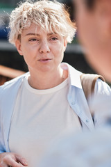 Fototapeta na wymiar Portrait of short haired blond mid age woman