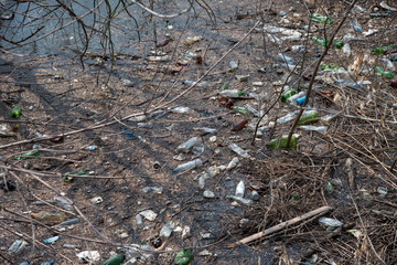 plastic bottles and other rubbish in river water. pollution of the oceans and the environment. harm to nature