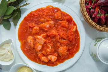 Tomato Pickle . Chicken and tomatoes . Red Dry Pepper in Traditional Basket . Tomato Pickle . Chakhokhbili - chicken stewed with tomatoes and onions. salt, pepper. Red Dry Pepper in Basket .