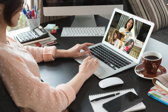 Asian woman work from home during corona virus, COVID-19 out break use laptop for teleconference with her teamates