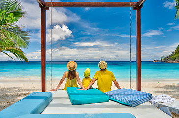 Family with three year old boy on beach. Seychelles, Mahe.