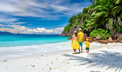 Family with three year old boy on beach. Seychelles, Mahe. - obrazy, fototapety, plakaty